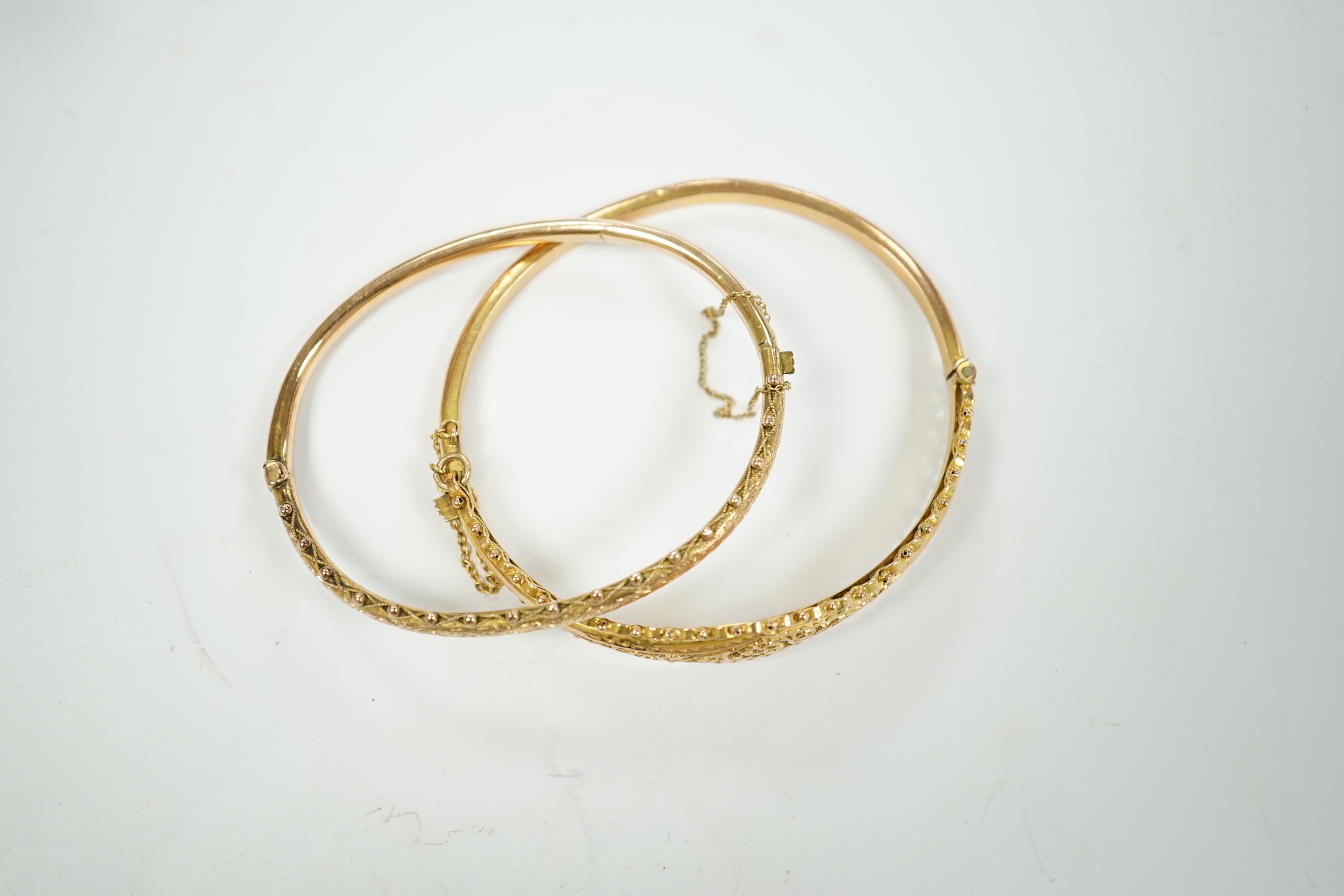 Two yellow metal hinged bracelets, one stamped 9ct gold, hallmarked bracelet 9.2 grams.